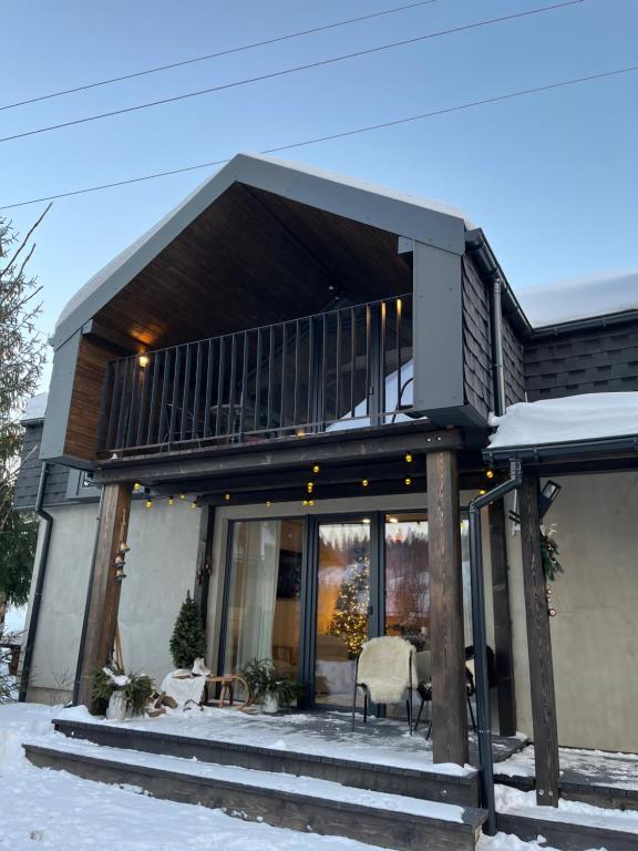 a house with a balcony in the snow at UGRAD family in Slavske