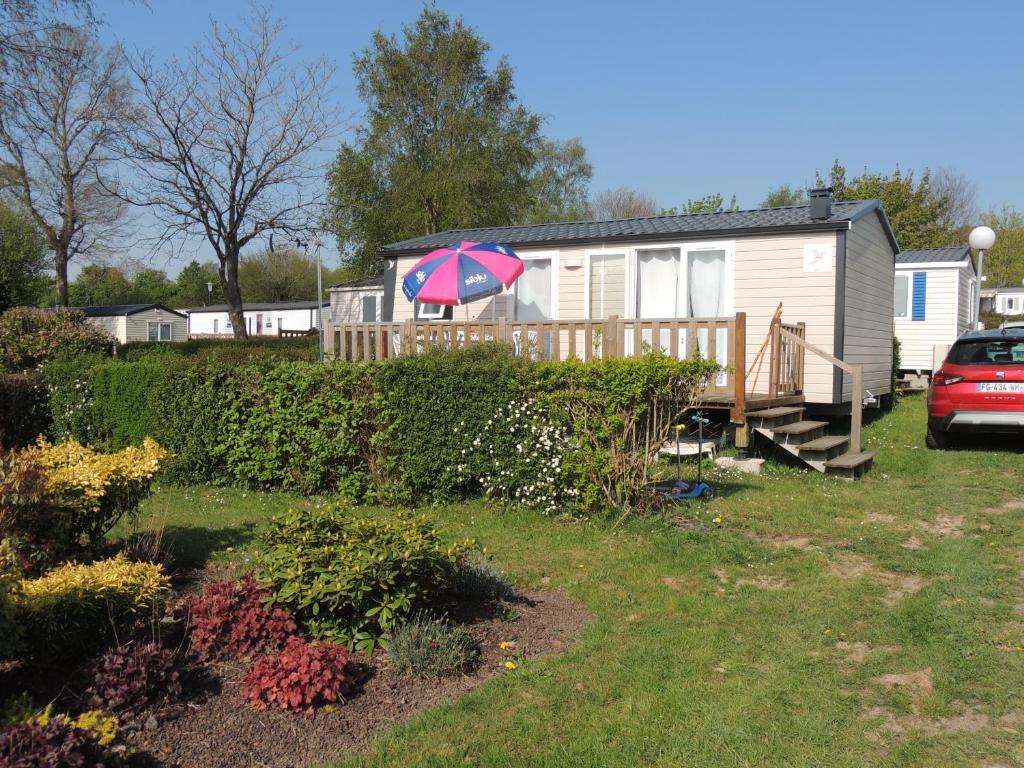 ein Haus mit einem Regenschirm im Hof in der Unterkunft Chez Loulou et Belette MH048 in Litteau