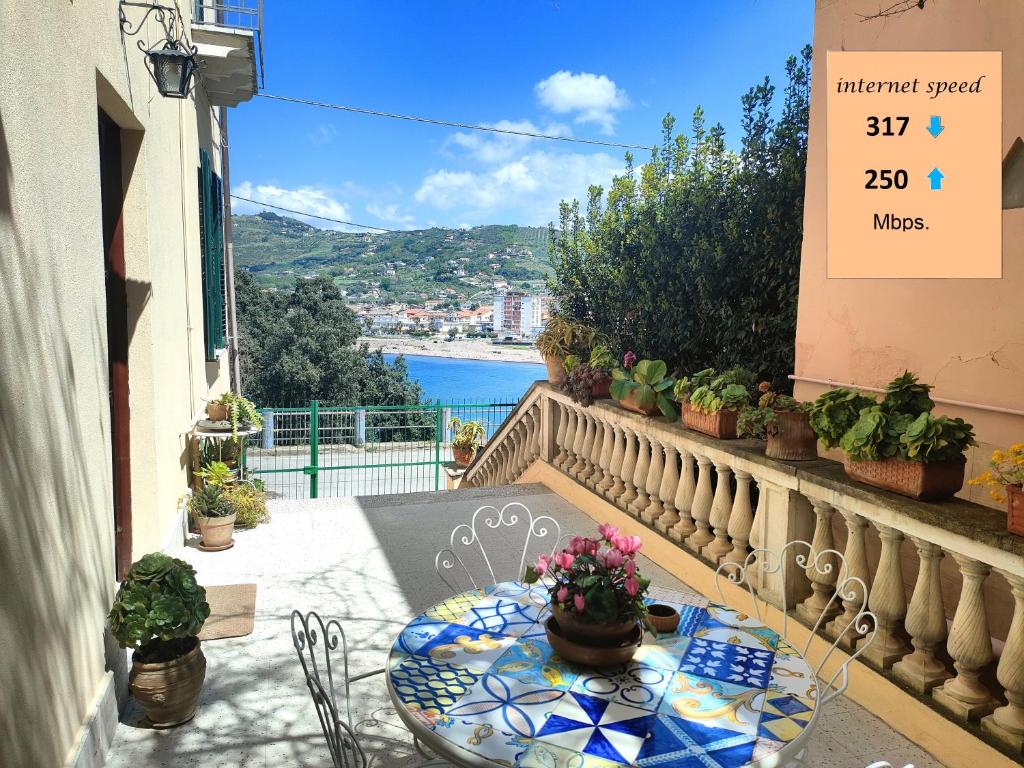 a table on a balcony with a view of the water at Panoramic Apartment in Villa on The Beach, In Center in Agropoli