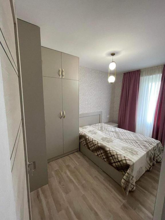 a small bedroom with a bed and a cabinet at My Sweet Home In Rustavi City 3 in Rustavi