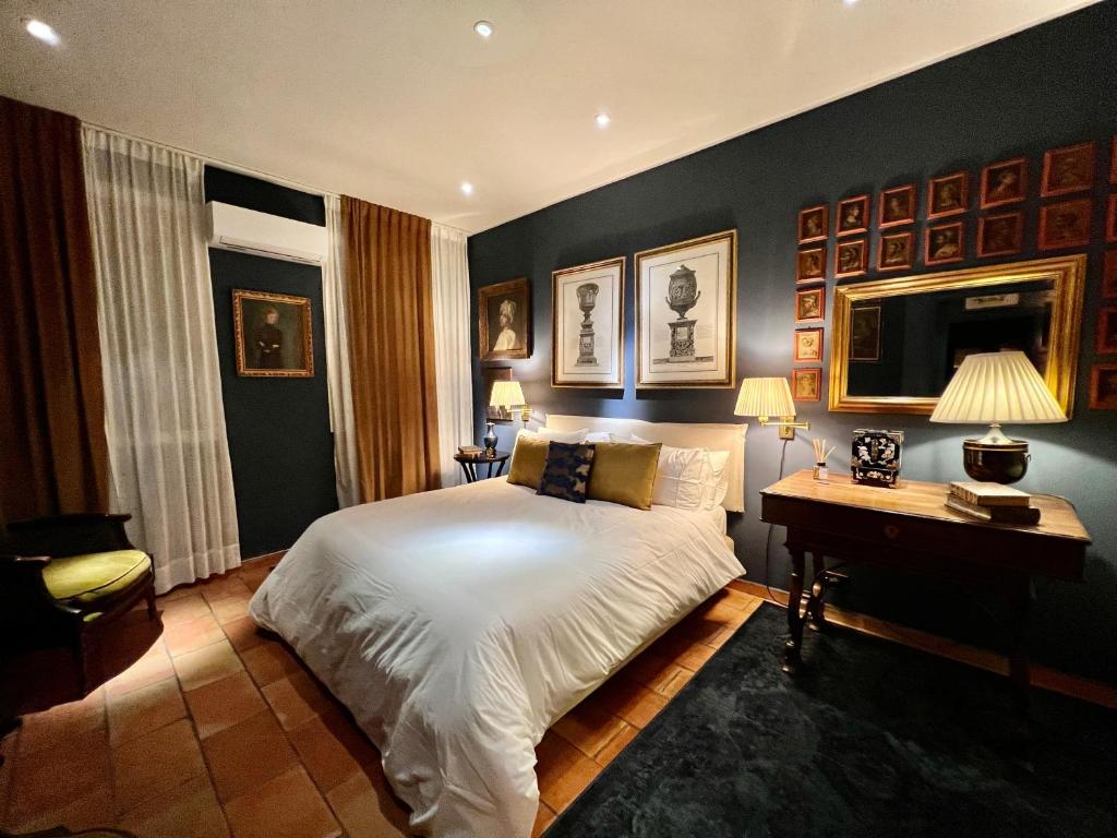 a bedroom with a bed and a desk with two lamps at CHALET MARMONT ROME in Rome
