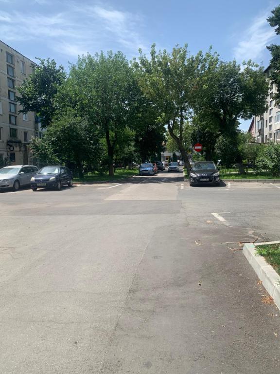 an empty parking lot with cars parked on the street at Apartament in complex rezidențial in Râmnicu Vâlcea
