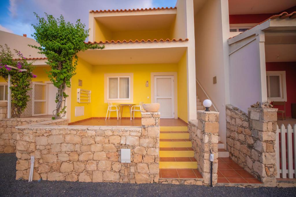 a house with yellow walls and yellow stairs at Appartamento LULA. Stella Maris Exclusive in Calheta Do Maio