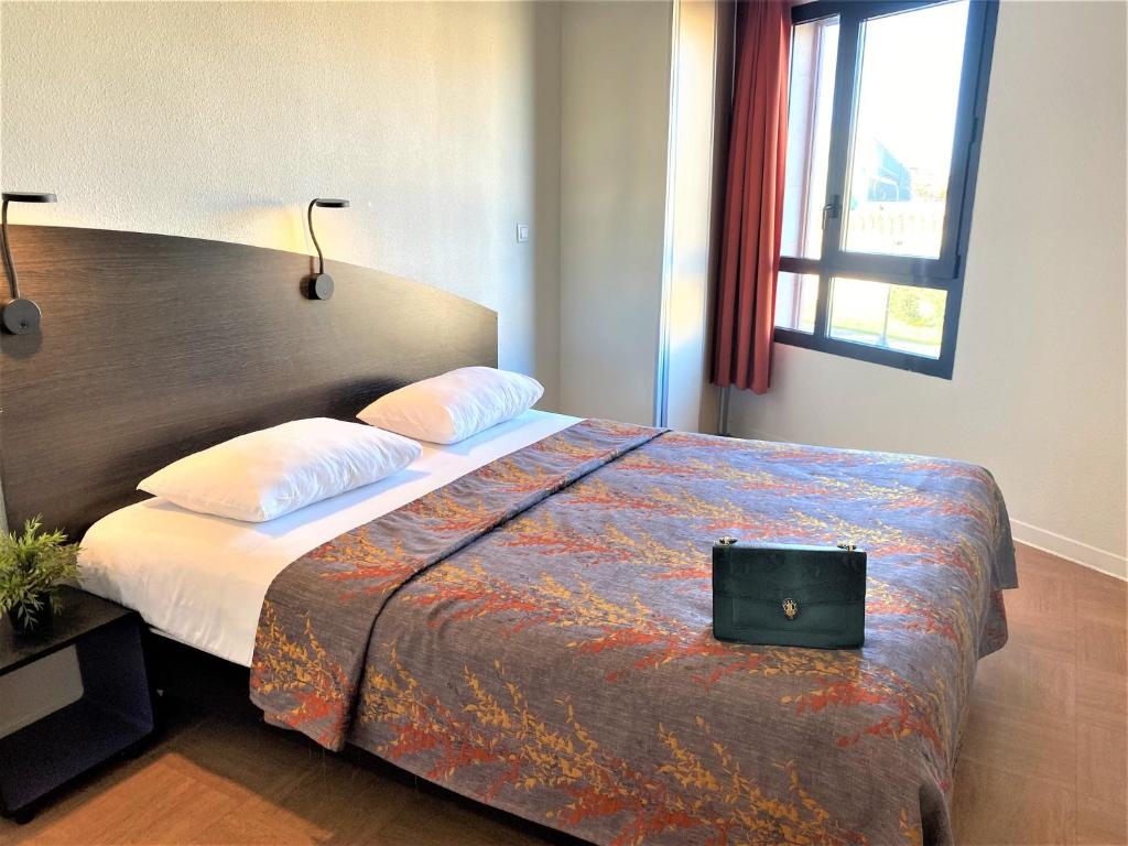 Postel nebo postele na pokoji v ubytování ApartHotel Sainte-Marthe
