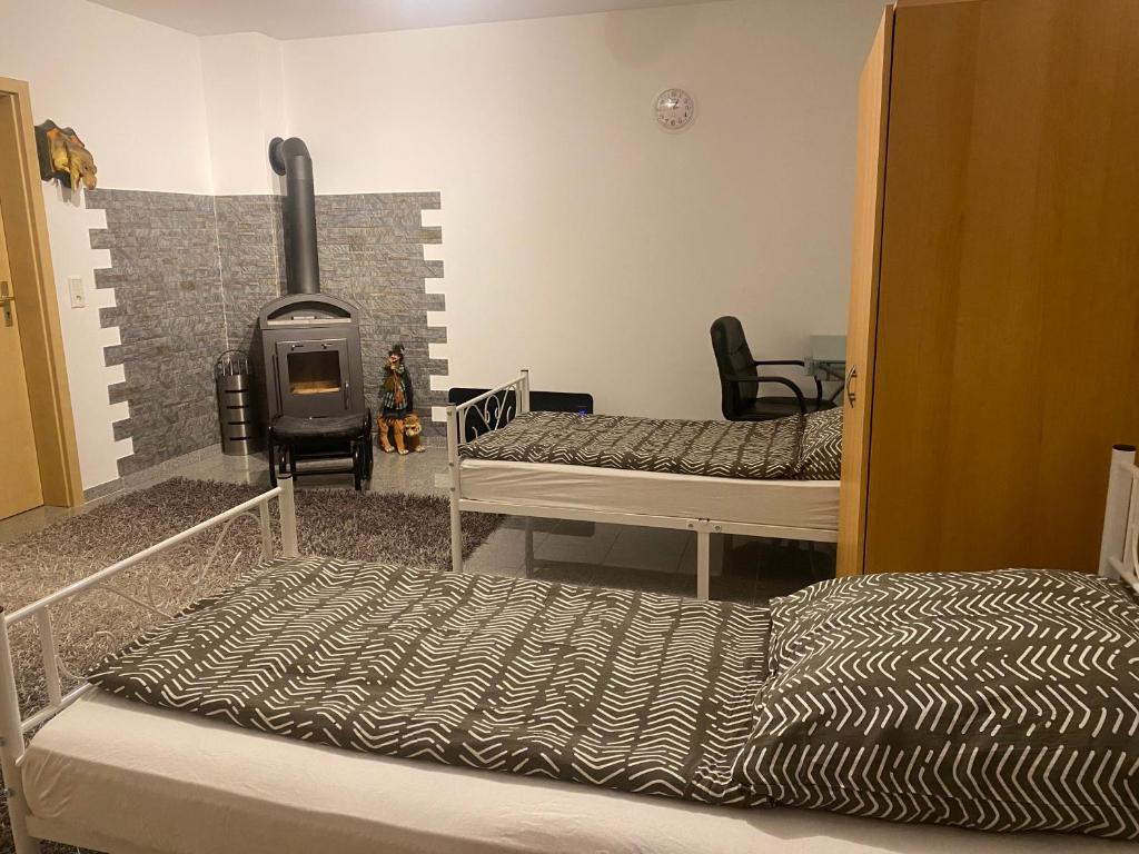 a room with two beds and a fireplace in it at Ferienwohnung Patrick in Amberg