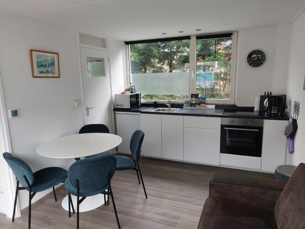 a kitchen with a table and chairs and a table at Huize Visser in Egmond aan Zee