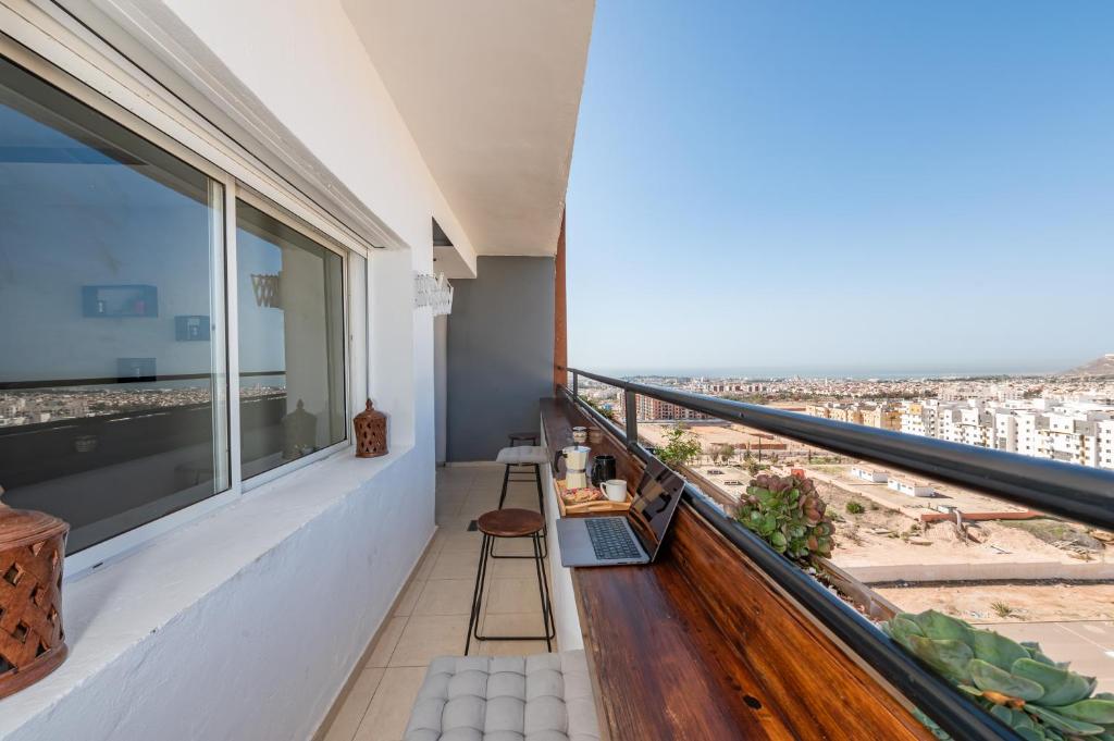 a balcony with a view of the city at Appartement en résidence avec piscine in Agadir