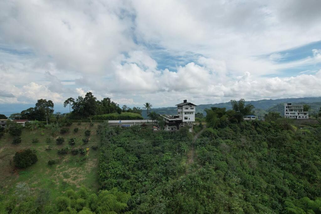 a house sitting on top of a hill at Villa tikuna in Mariquita