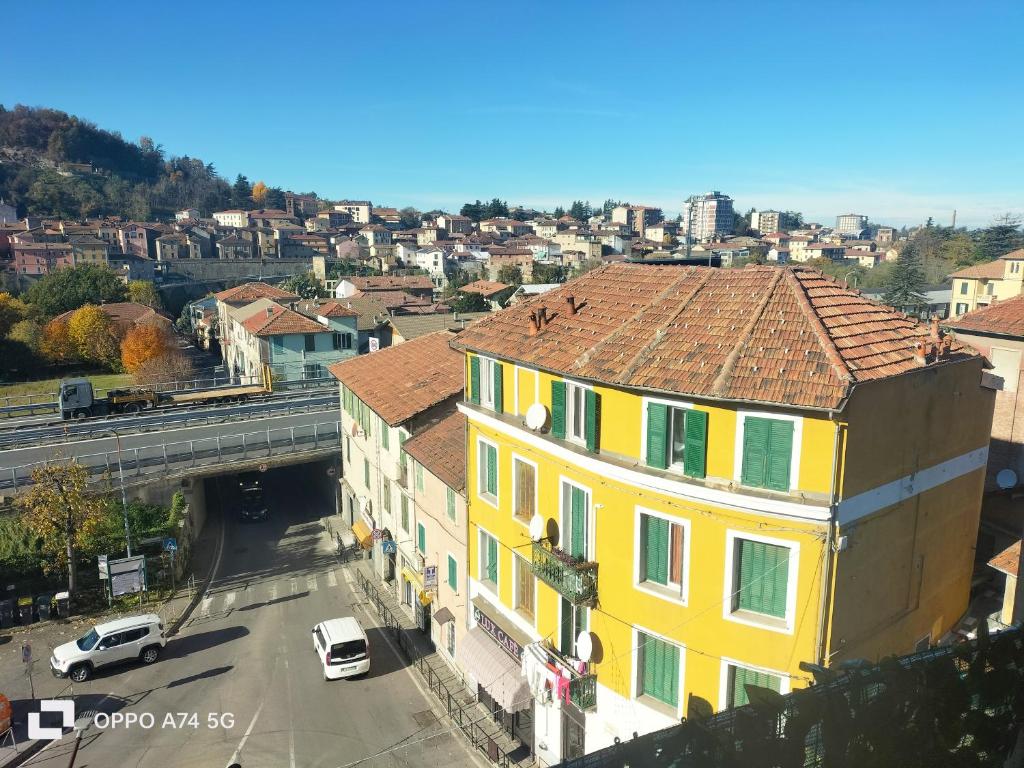 a yellow building on a city street with a bridge at Serravalle Apartment 2 in Serravalle Scrivia