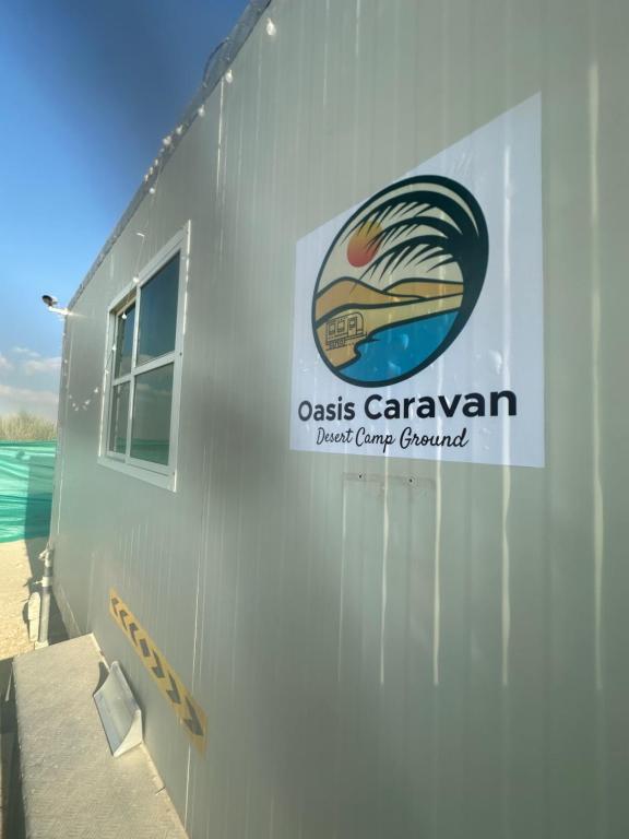 a building with a sign on the side of it at Oasis Caravan in Dubai