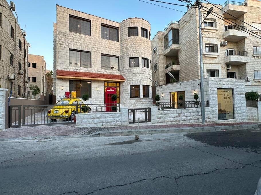 a yellow car parked in front of a building at 5/ Antica jabalal-lwebdeh in Amman