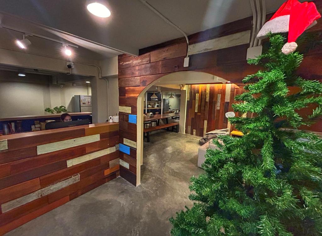 a christmas tree in the middle of a restaurant at Qilombo Hostel Silom - HQ in Bangkok