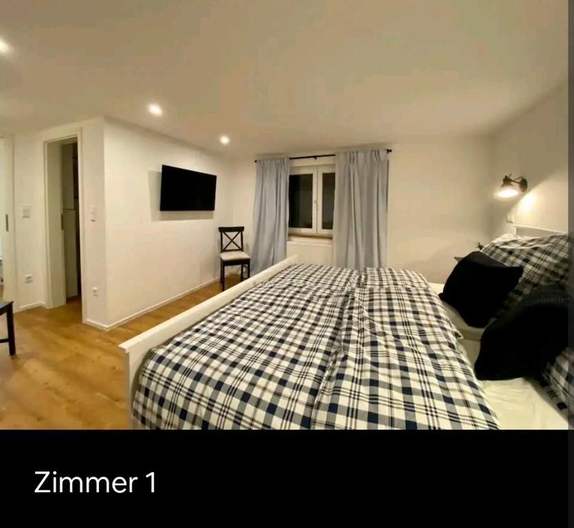 a bedroom with a bed and a tv in it at Reiter's Apartments am Eichelberg in Gaggenau