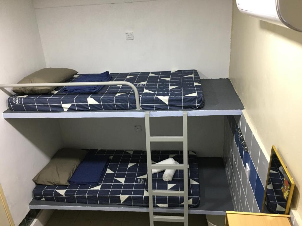 Postel nebo postele na pokoji v ubytování Thian Siong Inn