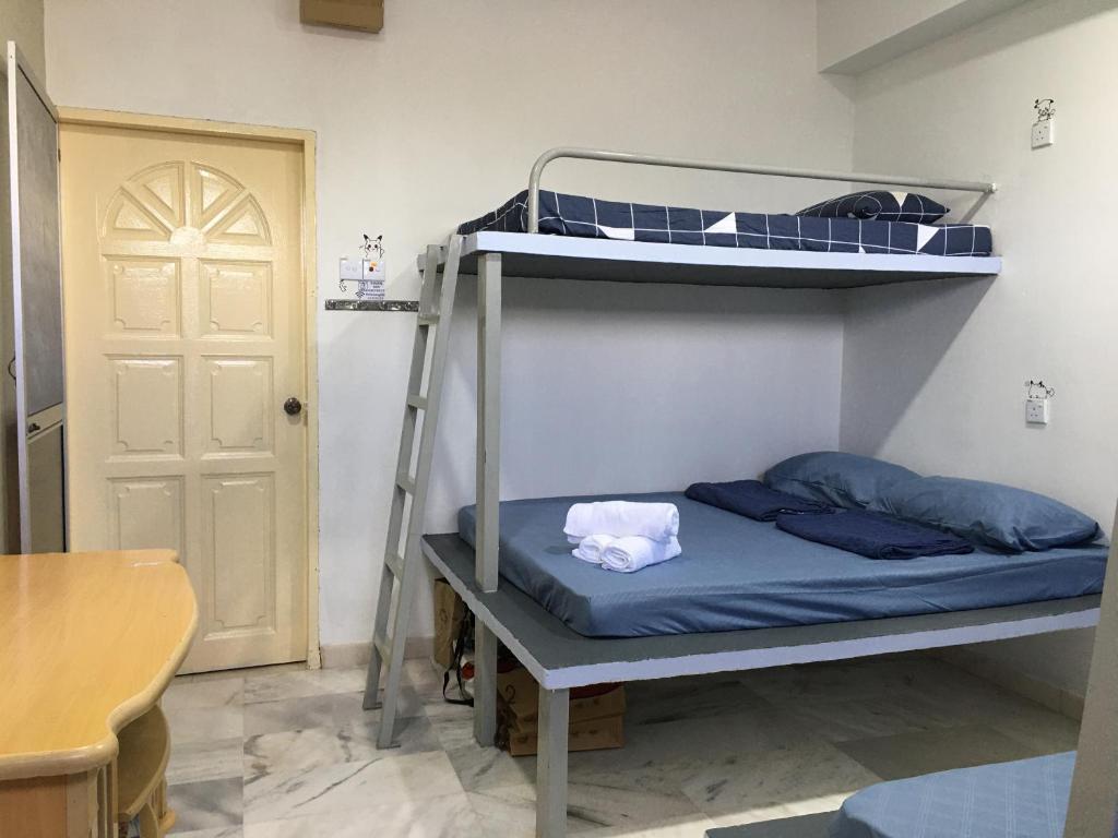 Postel nebo postele na pokoji v ubytování Thian Siong Inn