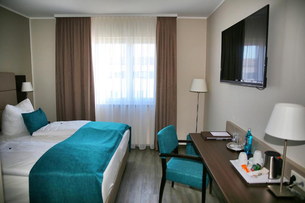Postel nebo postele na pokoji v ubytování hotel bomonti Nürnberg West