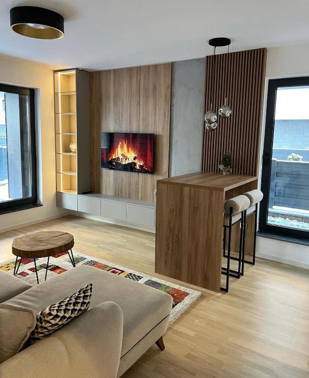 a living room with a fireplace in the wall at Arbor Apartment in Bjelašnica
