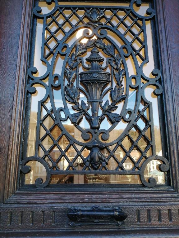 a close up of a metal door with a window at "LA MAIN D'OR " avec espaces Sauna et salle de Sport in Spa