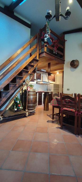 a room with a staircase and a table and benches at Spritz's Home in Castel di Sangro