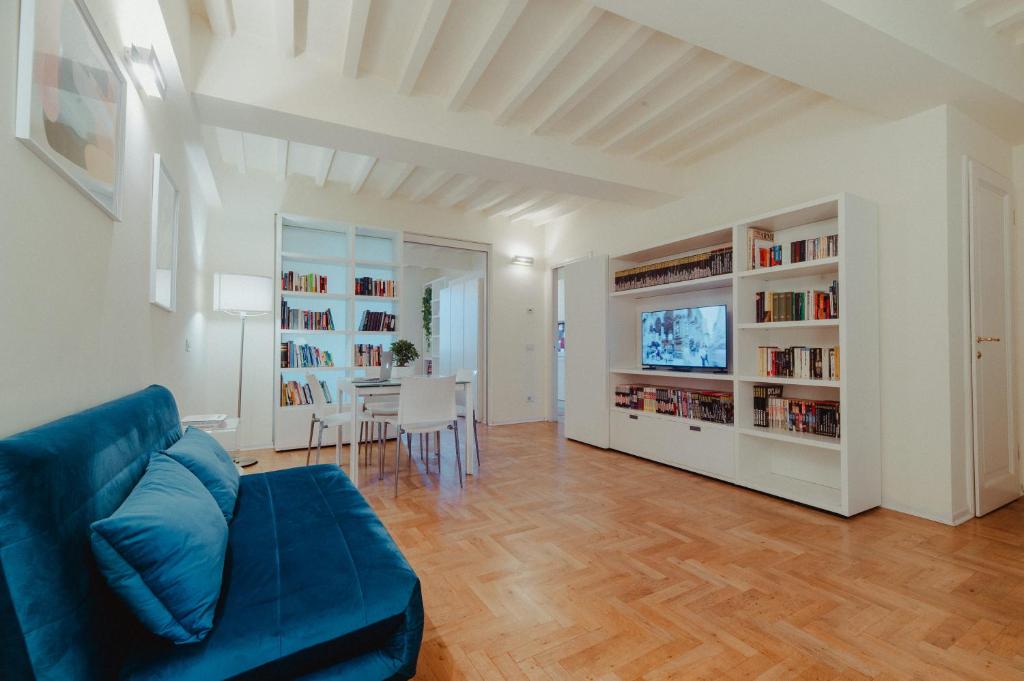 a living room with a blue couch and a television at Vista e Tetti ai Canacci in Florence