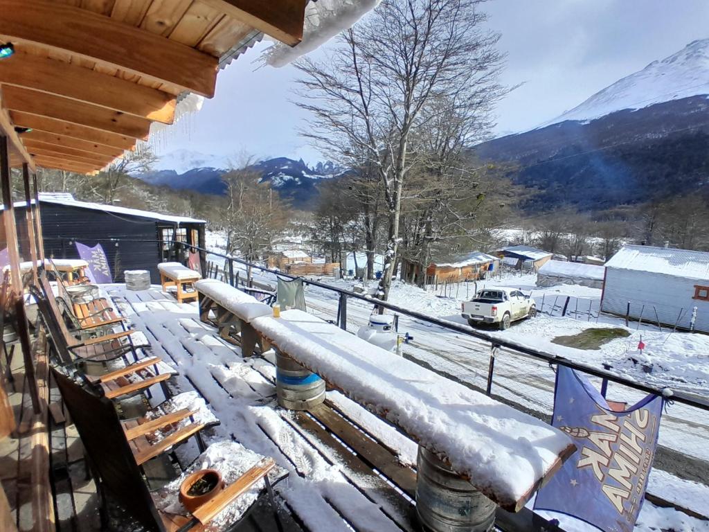 a snow covered balcony with a view of a snow covered mountain at Cabaña del Glaciar, al pie del glaciar vinciguerra zona ramsar in Ushuaia