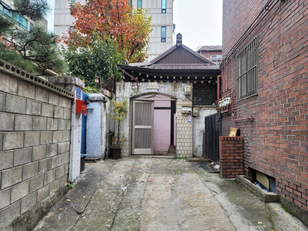 um beco com uma porta roxa e um edifício em BlueBird Guesthouse - Foreign Only em Seul