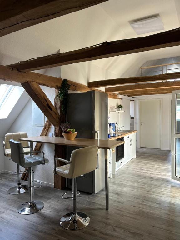 a kitchen with a table and chairs in a room at Zur Scheune in Bad Wildungen