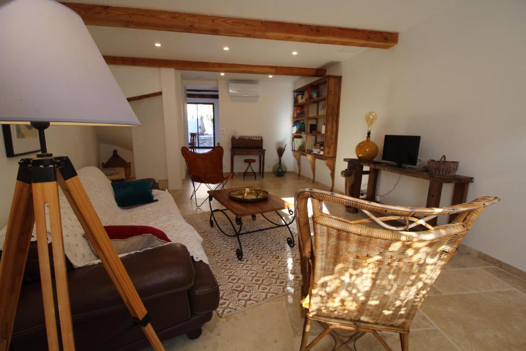 a living room with a couch and a chair at Gite sur la Founintrouze in Fabrezan