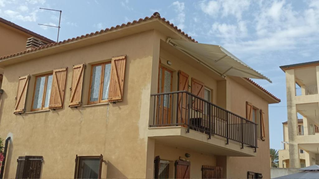 una casa con un balcón encima en Casa Mariuccia, en Valledoria