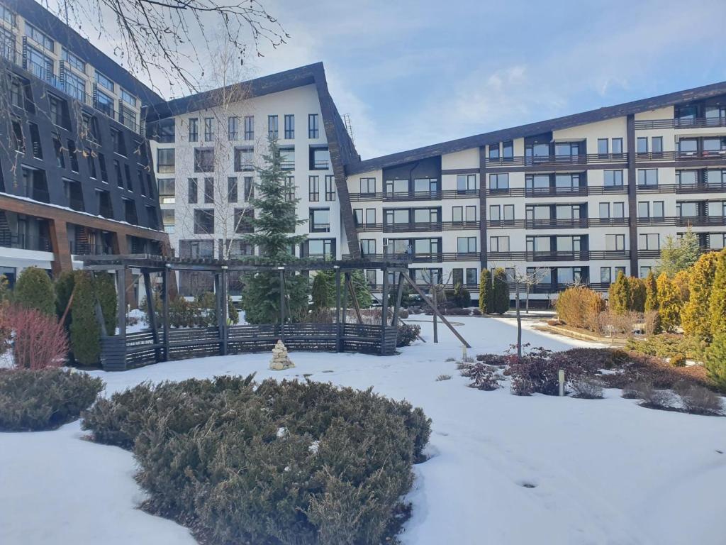 a snow covered courtyard in front of a building at Aspen Valley B304 in Razlog