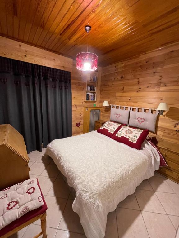 a bedroom with a bed in a wooden room at Gréolières La Floconnière in Gréolières