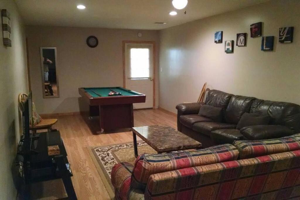 a living room with a couch and a pool table at Barn house in Saint Joe