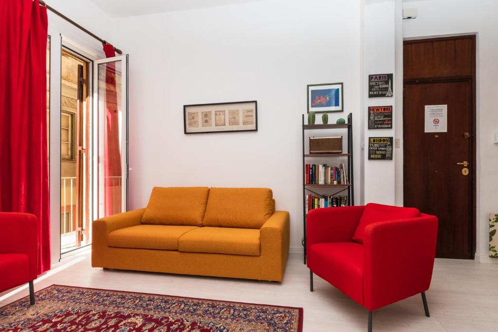 a living room with a couch and two chairs at Casa Soliva in Palermo