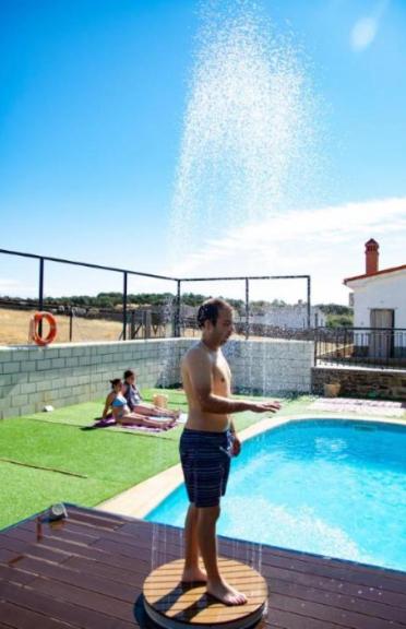a man standing on a board in front of a fountain at Apartamento Loft La Encina in Torrejón el Rubio