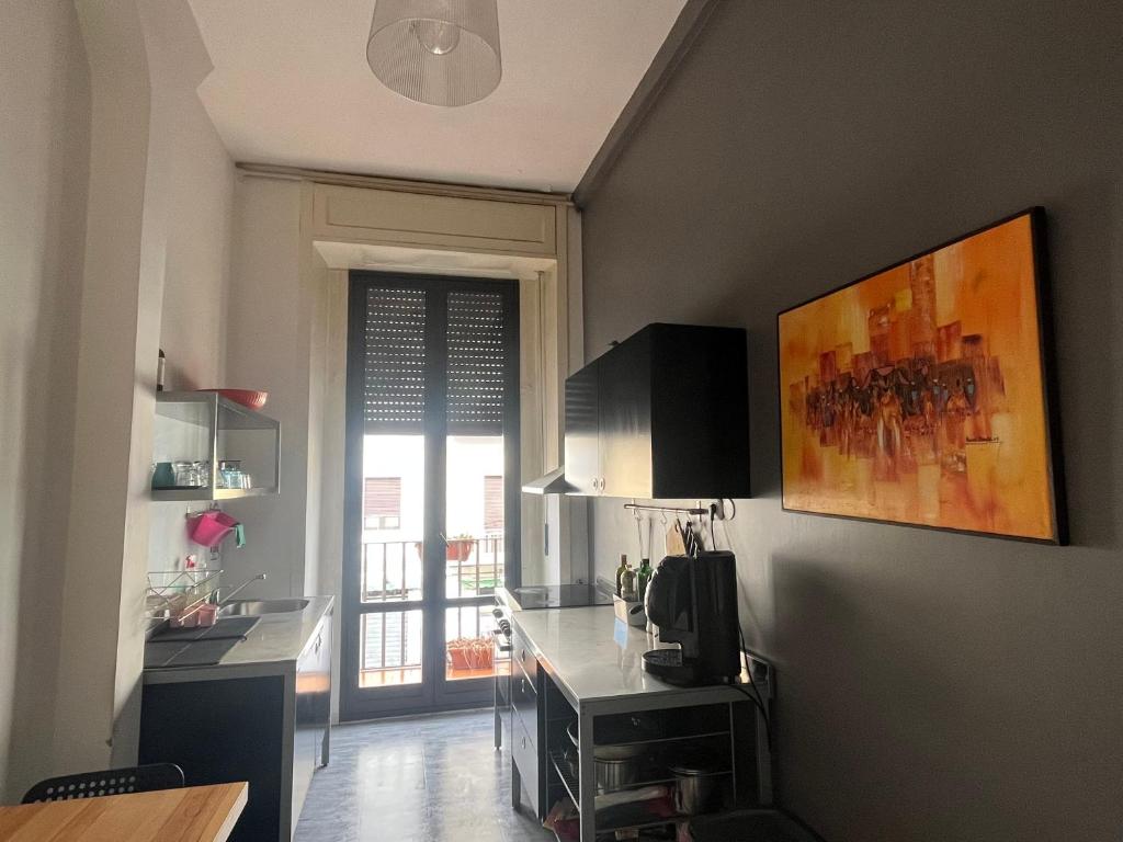 a kitchen with a large window and a kitchen counter at Deodato Guest House in Catania