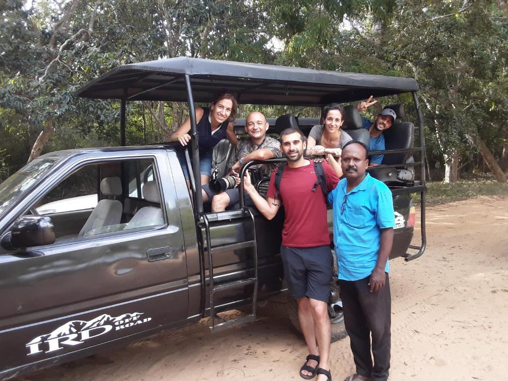 a group of people standing next to a truck at LLT budget room WILPATTU in Nochchiyagama