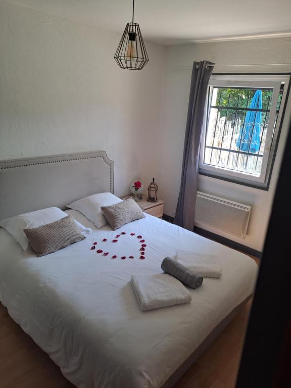 a bedroom with a bed with a heart drawn on it at Le gîte des cascades in Bassy