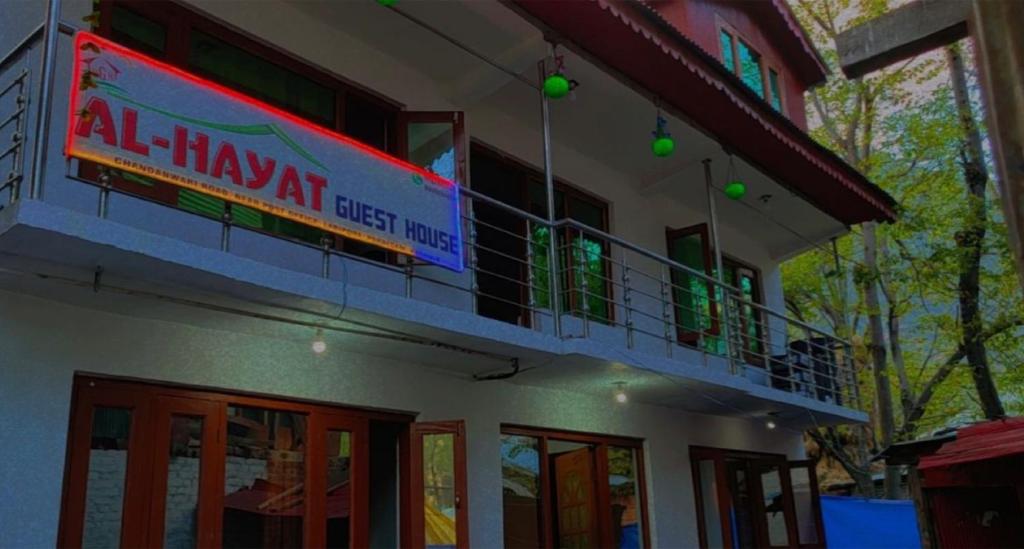 a building with a sign that reads all may art guest house at Al Hayat Guest House in Pahalgām