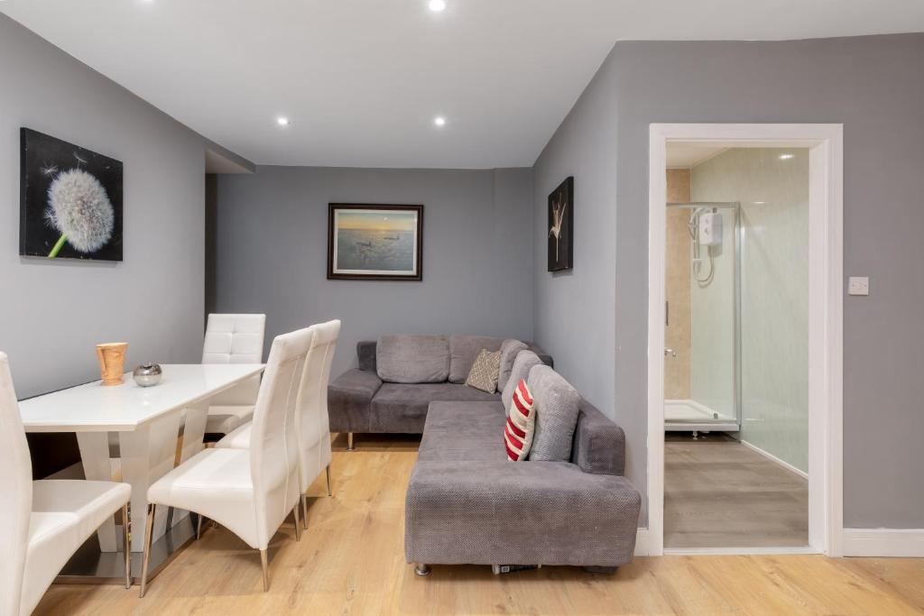 a living room and dining room with a couch and a table at Central Apartment Darlington in Darlington