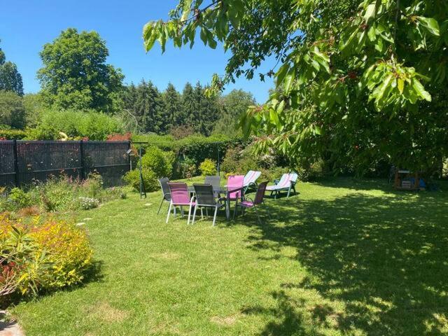 een groep stoelen in een tuin bij maison avec beau jardin arboré in Torcy