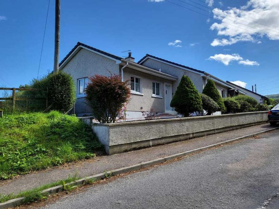 a house on the side of the road at Northlea-Scottish style cottage in Inverness