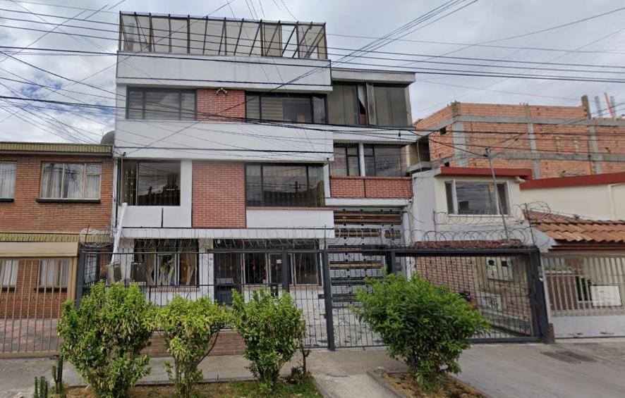 a tall brick building with trees in front of it at APARTASUITES BOGOTA 53 - 101a in Bogotá