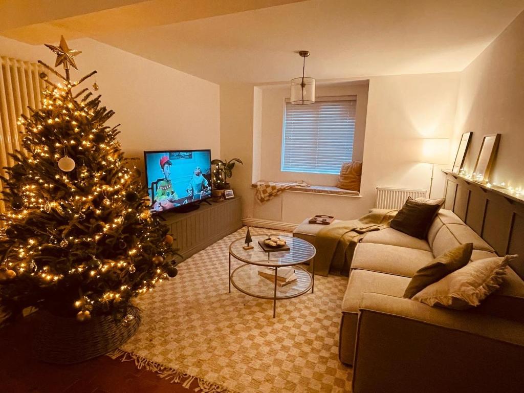 a living room with a christmas tree and a couch at Stylish, comfortable, convenient! in Bala