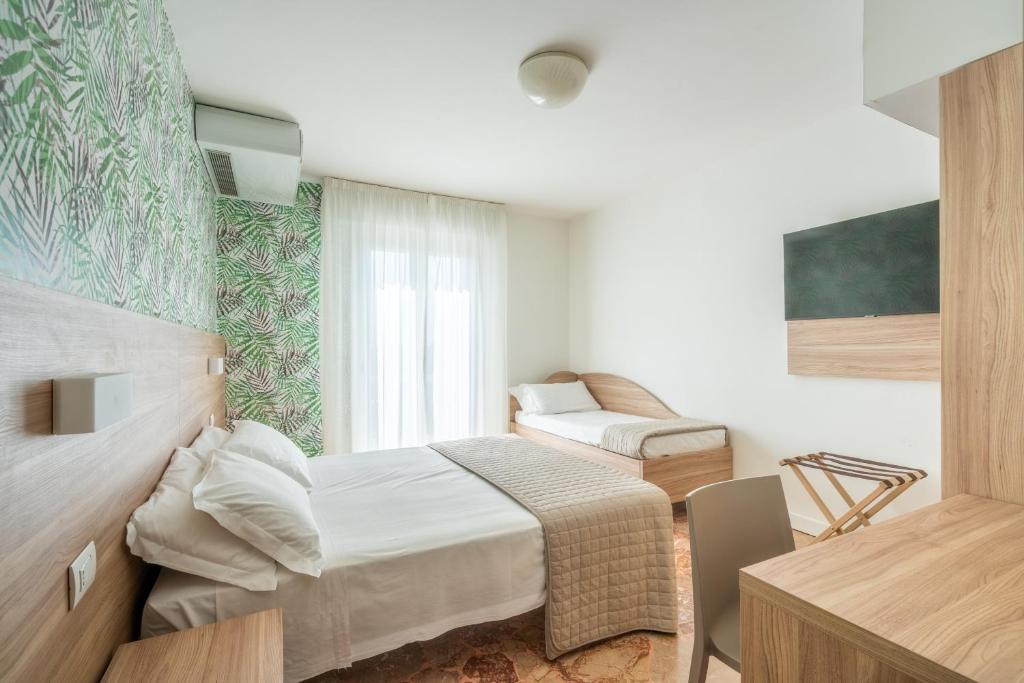 Postel nebo postele na pokoji v ubytování Lotus Hotel ALL INCLUSIVE & SPIAGGIA