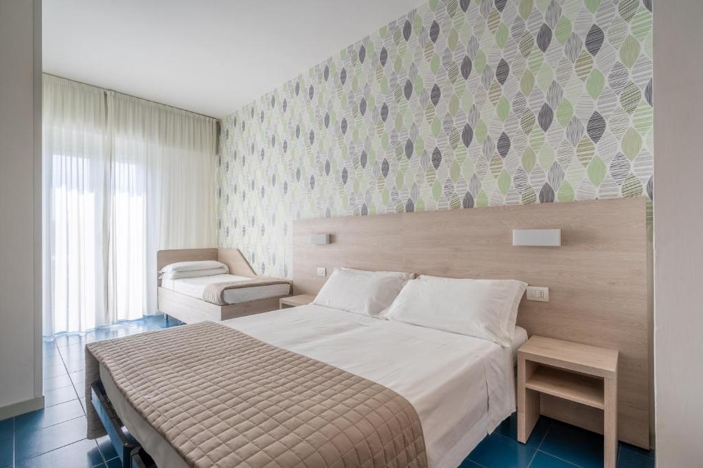 Postel nebo postele na pokoji v ubytování Lotus Hotel ALL INCLUSIVE & SPIAGGIA