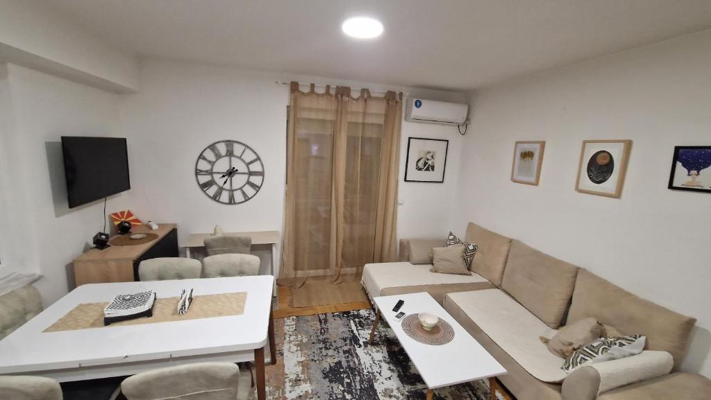 a living room with a couch and a table at Kris apartments in Skopje