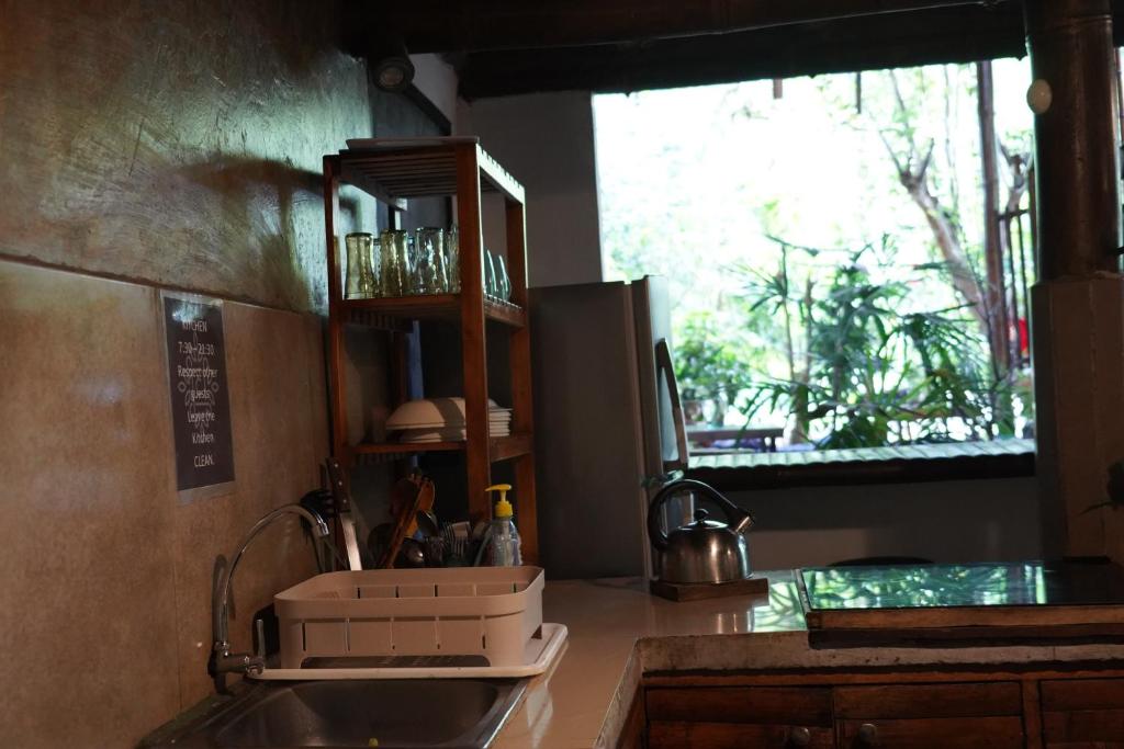 a kitchen counter with a sink and a window at Cinnamon House in Mindo