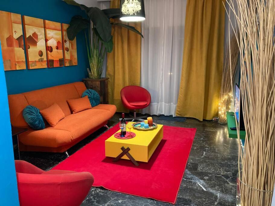 a living room with a couch and a table at Retro living apartment in Larisa