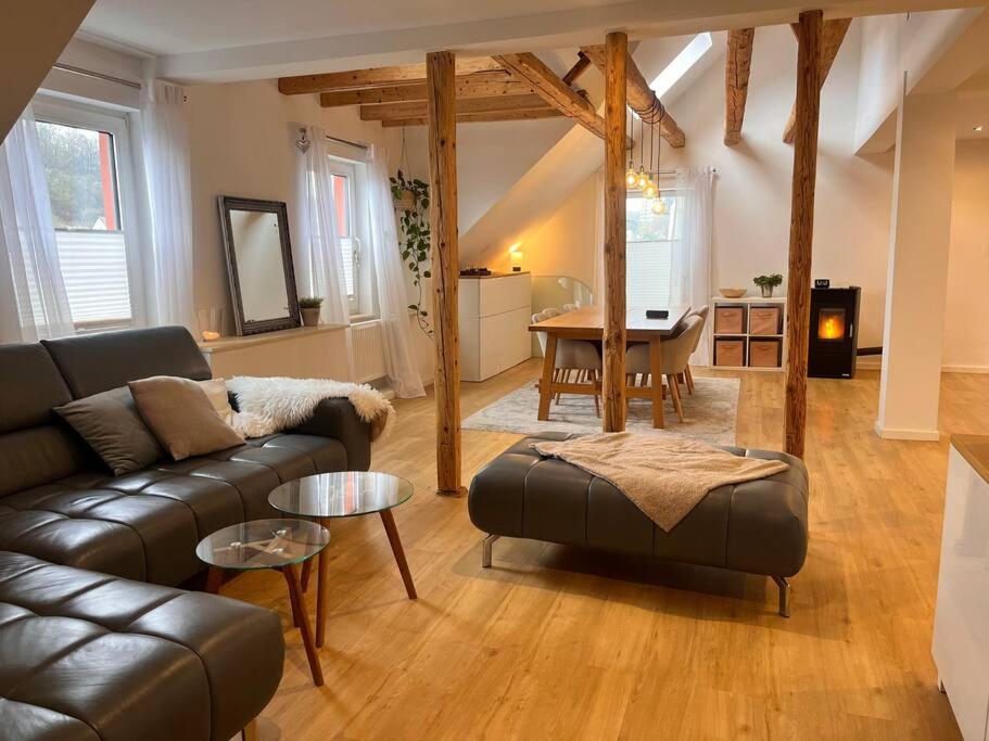 a living room with a couch and a table at Stilvolles Ferienhaus in Gerolstein in Gerolstein