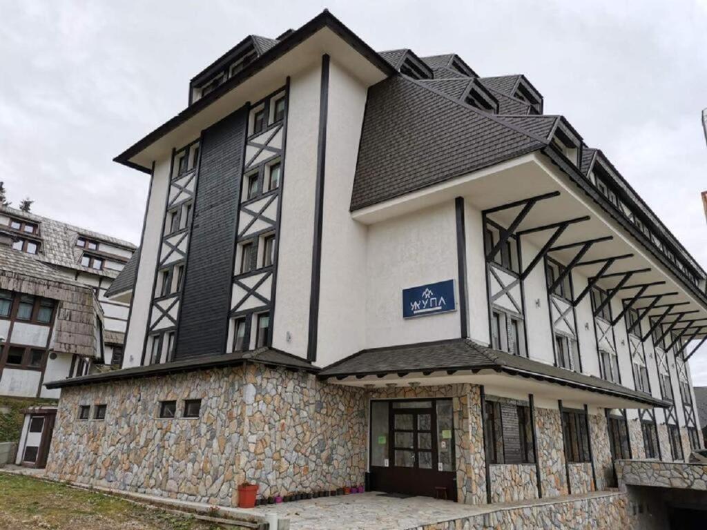 a large white building with a black roof at Apartment Župa 111, Župa Wellness & Spa, Kopaonik in Kopaonik